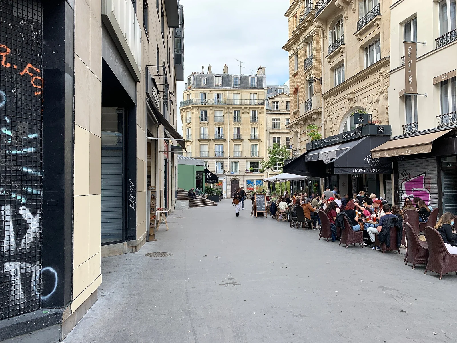 A pedestrian street with café terraces on Rue Mondétour in present-day Paris.
