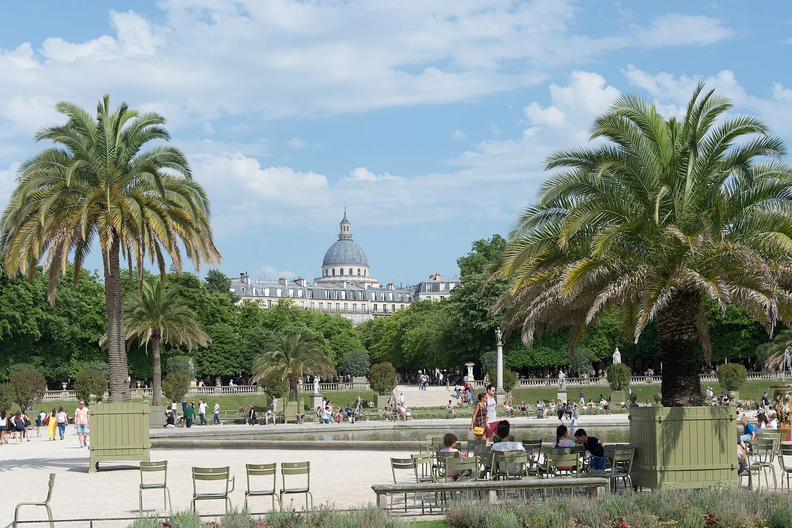Green chairs, palms and garden terraces at the Luxembourg Gardens, with the Panthéon in the distance.